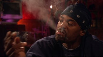 Movie still from “How High” (2001), directed by Jesse Dylan – A person smoking a cigarette; Close Up shot, Low angle