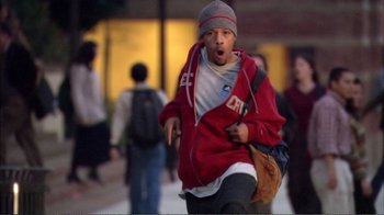 Movie still from “How High” (2001), directed by Jesse Dylan – A man in a red jacket is running in the street; Medium shot, Low angle