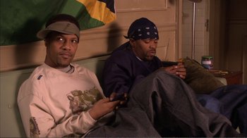 Movie still from “How High” (2001), directed by Jesse Dylan – A couple of men sitting next to each other on a couch; Medium shot, Low angle