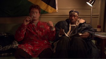 Movie still from “How High” (2001), directed by Jesse Dylan – A couple of men sitting next to each other on top of a bench; Medium shot, High angle