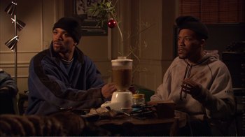 Movie still from “How High” (2001), directed by Jesse Dylan – A couple of men sitting at a table with a drink; Medium shot, Low angle