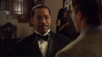 Movie still from “How High” (2001), directed by Jesse Dylan – A man in a suit and bow tie talking to another man; Close Up shot, Over the shoulder angle