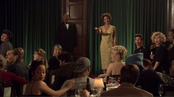 Movie still from “How High” (2001), directed by Jesse Dylan – A group of people sitting around a table; Wide shot, Over the shoulder angle