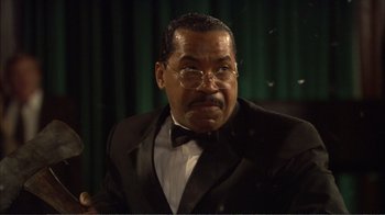 Movie still from “How High” (2001), directed by Jesse Dylan – An older man in a suit and bow tie; Close Up shot, Low angle