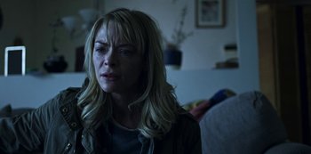 Movie still from “Black Summer” (2019), created by John Hyams – A woman with blonde hair is looking at the camera; Close Up shot, Over the shoulder angle
