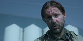 Movie still from “Black Summer” (2019), created by John Hyams – A person with long hair; Close Up shot, Over the shoulder angle