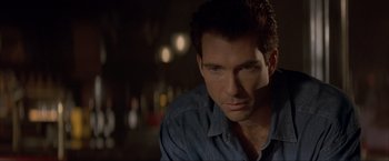 Movie still from “In the Line of Fire” (1993), directed by Wolfgang Petersen – A person wearing a blue shirt; Close Up shot, Over the shoulder angle