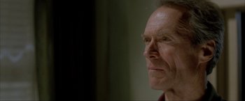 Movie still from “In the Line of Fire” (1993), directed by Wolfgang Petersen – An older man looking into the distance with a serious look; Close Up shot, Low angle