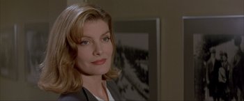 Movie still from “In the Line of Fire” (1993), directed by Wolfgang Petersen – A person wearing a suit and tie; Close Up shot, Low angle