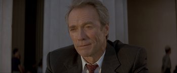 Movie still from “In the Line of Fire” (1993), directed by Wolfgang Petersen – An older man wearing a suit and tie; Close Up shot, High angle