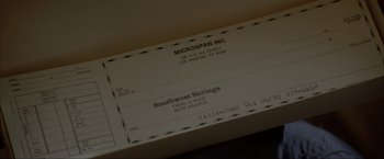 Movie still from “In the Line of Fire” (1993), directed by Wolfgang Petersen – A receipt of southwest savings; Extreme Close Up shot, Overhead angle