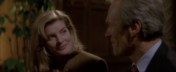 Movie still from “In the Line of Fire” (1993), directed by Wolfgang Petersen – A man and a woman talking to each other; Close Up shot, Over the shoulder angle