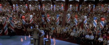 Movie still from “In the Line of Fire” (1993), directed by Wolfgang Petersen – A crowd of people in a room with balloons; Extreme Wide shot, High angle