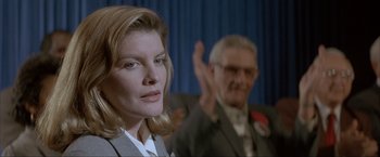 Movie still from “In the Line of Fire” (1993), directed by Wolfgang Petersen – A woman and an older man clapping in front of each other; Close Up shot, Low angle