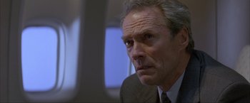 Movie still from “In the Line of Fire” (1993), directed by Wolfgang Petersen – An older man in a suit and tie looking to his left; Close Up shot, Low angle
