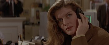 Movie still from “In the Line of Fire” (1993), directed by Wolfgang Petersen – A person with long blonde hair; Close Up shot, Low angle