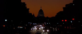 Movie still from “In the Line of Fire” (1993), directed by Wolfgang Petersen – A city street filled with lots of traffic at night; Extreme Wide shot, Low angle