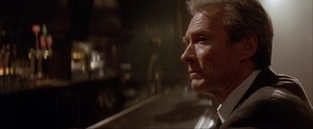 Movie still from “In the Line of Fire” (1993), directed by Wolfgang Petersen – An older man looking off into the distance; Close Up shot, Low angle