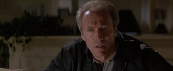 Movie still from “In the Line of Fire” (1993), directed by Wolfgang Petersen – A person wearing a jacket; Close Up shot, Over the shoulder angle