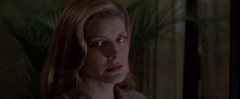 Movie still from “In the Line of Fire” (1993), directed by Wolfgang Petersen – A person with long blonde hair; Close Up shot, Low angle