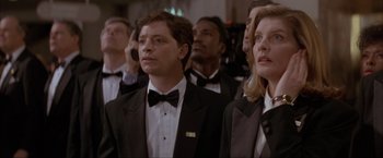 Movie still from “In the Line of Fire” (1993), directed by Wolfgang Petersen – A group of people wearing tuxedos and bow ties; Close Up shot, Low angle