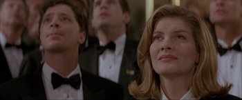 Movie still from “In the Line of Fire” (1993), directed by Wolfgang Petersen – A man and a woman in tuxedos looking at something; Close Up shot, Low angle