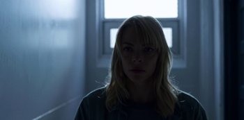 Movie still from “Black Summer” (2019), created by John Hyams – A woman standing in front of a window in the dark; Close Up shot, Low angle
