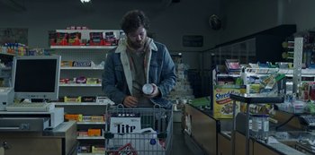 Movie still from “Black Summer” (2019), created by John Hyams – A man is pushing a shopping cart in a grocery store; Medium shot, Low angle