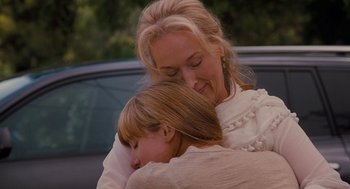 Movie still from “It's Complicated” (2009), directed by Nancy Meyers – A woman and a child hugging in front of a car; Close Up shot, Over the shoulder angle