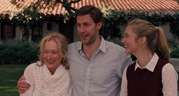 Movie still from “It's Complicated” (2009), directed by Nancy Meyers – Two women and a man standing next to each other; Medium shot, Over the shoulder angle