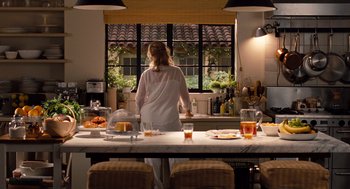 Movie still from “It's Complicated” (2009), directed by Nancy Meyers – A woman standing at a kitchen counter looking out the window; Wide shot, High angle