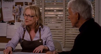 Movie still from “It's Complicated” (2009), directed by Nancy Meyers – A woman sitting at a table talking to a man; Medium shot, Over the shoulder angle