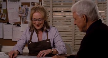 Movie still from “It's Complicated” (2009), directed by Nancy Meyers – A woman and a man sitting in front of a table; Medium shot, Over the shoulder angle