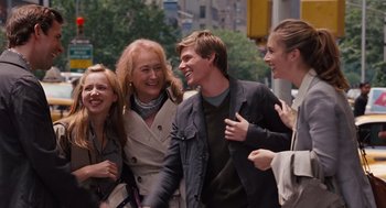 Movie still from “It's Complicated” (2009), directed by Nancy Meyers – A group of people standing next to each other on the street; Medium shot, Over the shoulder angle