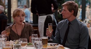 Movie still from “It's Complicated” (2009), directed by Nancy Meyers – A man and a woman sitting at a dinner table; Medium shot, Over the shoulder angle