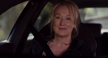 Movie still from “It's Complicated” (2009), directed by Nancy Meyers – A woman sitting in the driver's seat of a car; Close Up shot, Over the shoulder angle