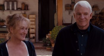 Movie still from “It's Complicated” (2009), directed by Nancy Meyers – A man and a woman standing next to each other outside; Medium shot, Over the shoulder angle