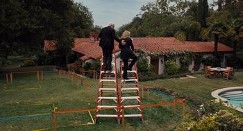 Movie still from “It's Complicated” (2009), directed by Nancy Meyers – A man and a woman standing on top of a ladder; Wide shot, Low angle