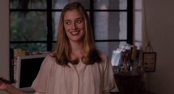 Movie still from “It's Complicated” (2009), directed by Nancy Meyers – A woman smiling for the camera in front of a window; Close Up shot, Over the shoulder angle