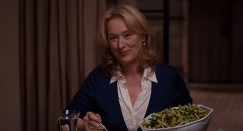 Movie still from “It's Complicated” (2009), directed by Nancy Meyers – A woman sitting in front of a plate of food; Close Up shot, Over the shoulder angle