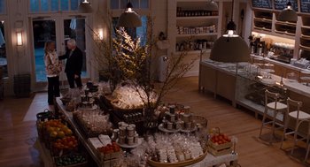 Movie still from “It's Complicated” (2009), directed by Nancy Meyers – A room filled with lots and lots of food on a table; Wide shot, Over the shoulder angle
