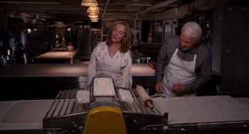 Movie still from “It's Complicated” (2009), directed by Nancy Meyers – A woman and a man working in a kitchen; Medium shot, Over the shoulder angle