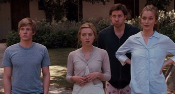 Movie still from “It's Complicated” (2009), directed by Nancy Meyers – A group of people standing next to each other on the grass; Medium shot, Over the shoulder angle