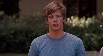 Movie still from “It's Complicated” (2009), directed by Nancy Meyers – A young man in a blue shirt is looking at the camera; Close Up shot, Over the shoulder angle