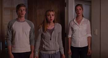 Movie still from “It's Complicated” (2009), directed by Nancy Meyers – A group of people standing next to each other in a room; Medium shot, Low angle