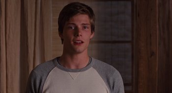 Movie still from “It's Complicated” (2009), directed by Nancy Meyers – A young man in a raglan shirt stares into the camera; Close Up shot, Over the shoulder angle