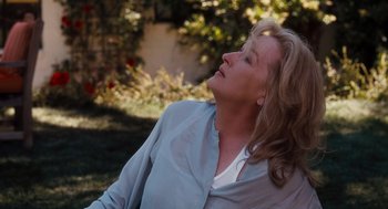 Movie still from “It's Complicated” (2009), directed by Nancy Meyers – A woman with her eyes closed in a garden; Close Up shot, Over the shoulder angle
