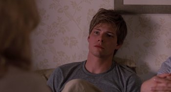 Movie still from “It's Complicated” (2009), directed by Nancy Meyers – A man sitting on a couch in front of a wall; Close Up shot, Over the shoulder angle