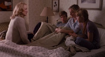 Movie still from “It's Complicated” (2009), directed by Nancy Meyers – A group of people sitting in a bed together; Medium shot, Over the shoulder angle