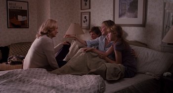 Movie still from “It's Complicated” (2009), directed by Nancy Meyers – A group of people sitting on a bed talking to each other; Wide shot, High angle
